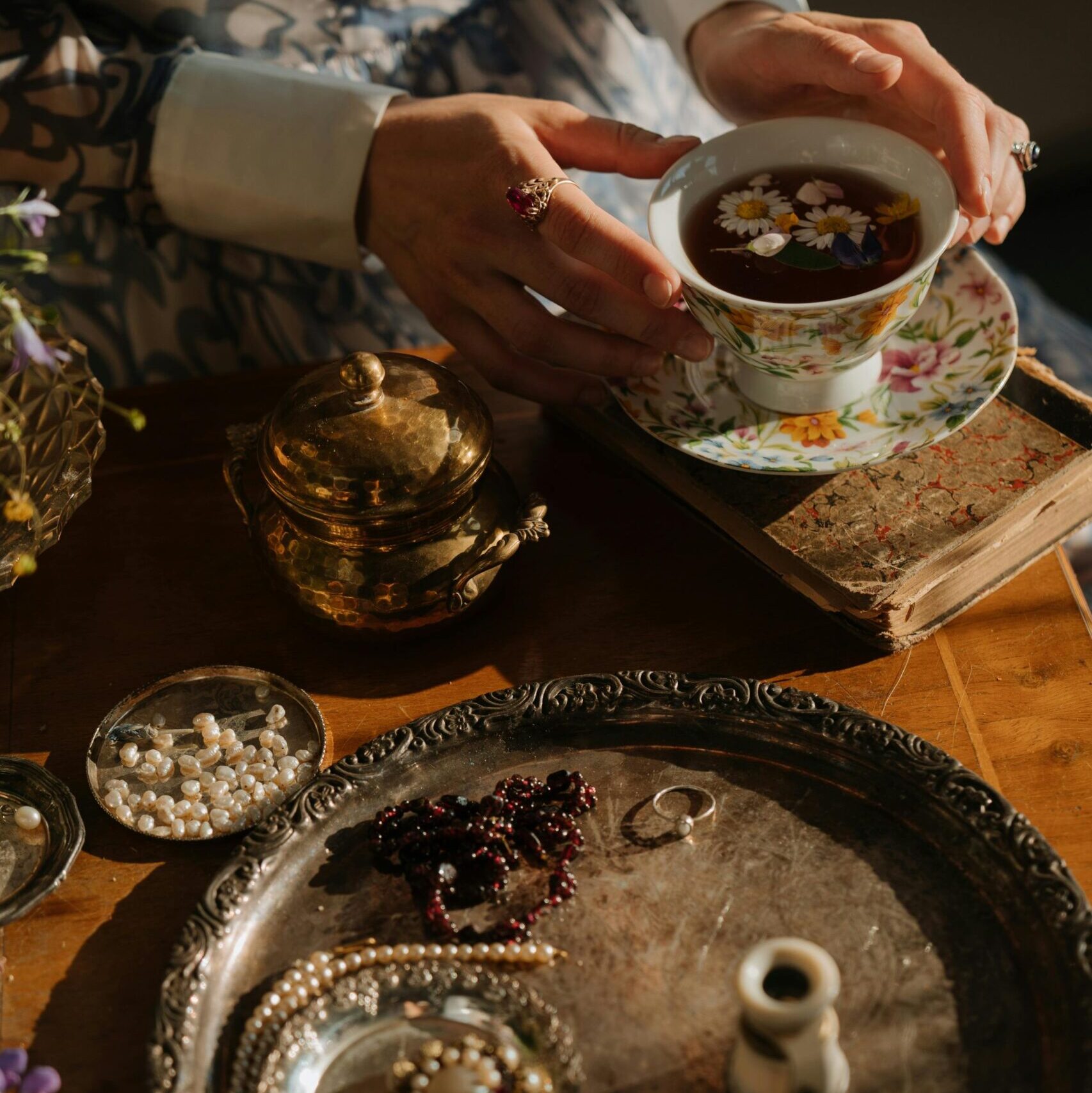 A classic tea scene featuring vintage porcelain, jewelry, and an elegant atmosphere, exemplifying Russian cultural style.